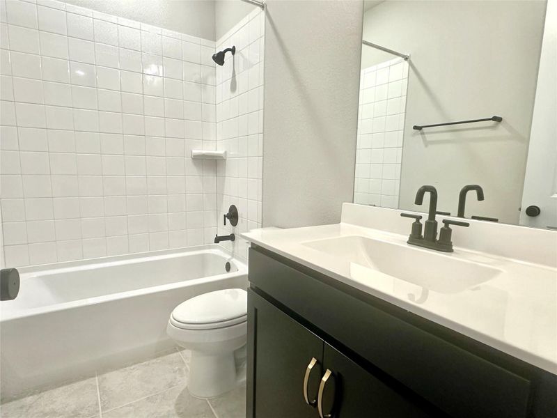 Bathroom 2-main floor- with toilet, shower / bath combination, vanity Bathroom 2-main floor- with toilet, shower / bath combination, vanity