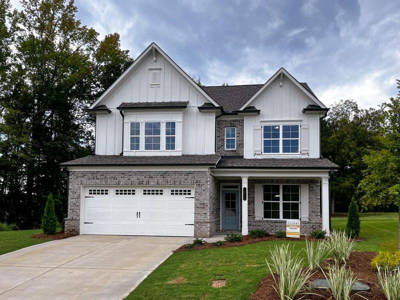 Front exterior of a new home in , Suwanee, GA, highlighting curb appeal (Image 1). Front exterior of a new home in , Suwanee, GA, highlighting curb appeal (Image 1).