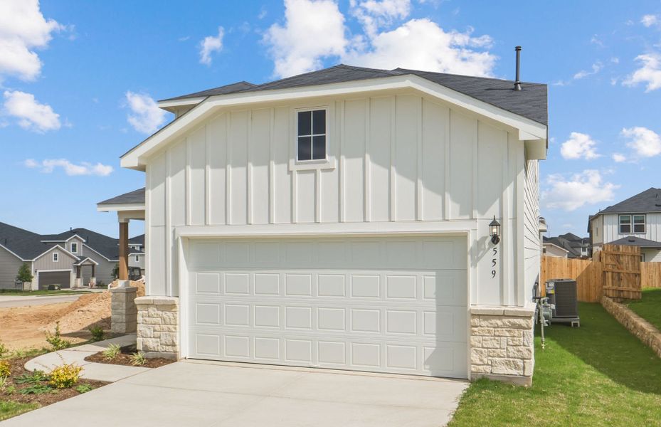 Front exterior of a new home in Sunfield, Buda, TX, highlighting curb appeal (Image 21). Front exterior of a new home in Sunfield, Buda, TX, highlighting curb appeal (Image 21).