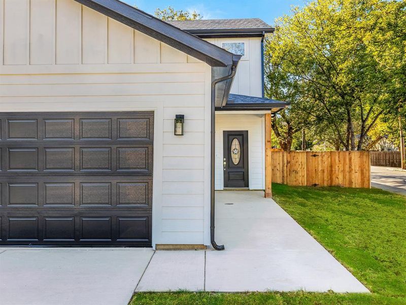 View of front of home featuring a shingled roof and board and batten siding