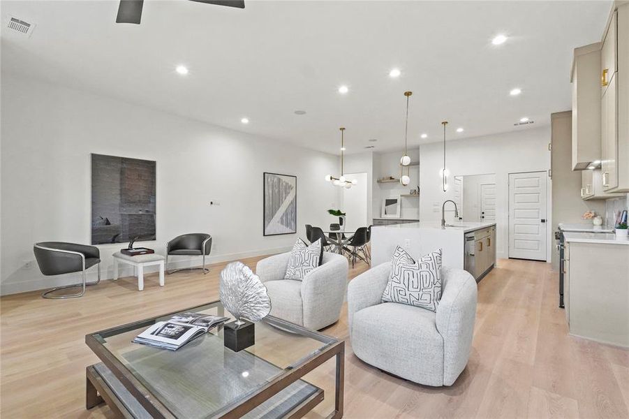 Living area featuring light wood-type flooring and recessed lighting
