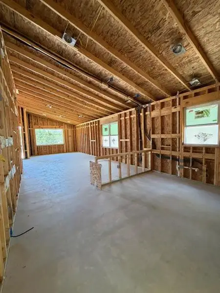 Framed walls and ceiling beams showcase the structural integrity of this emerging space. Framed walls and ceiling beams showcase the structural integrity of this emerging space.