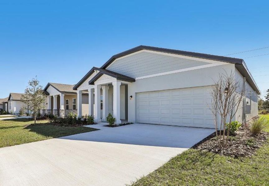 Front exterior of a new home in Sunbrooke, St. Cloud, FL, highlighting curb appeal (Image 1). Front exterior of a new home in Sunbrooke, St. Cloud, FL, highlighting curb appeal (Image 1).
