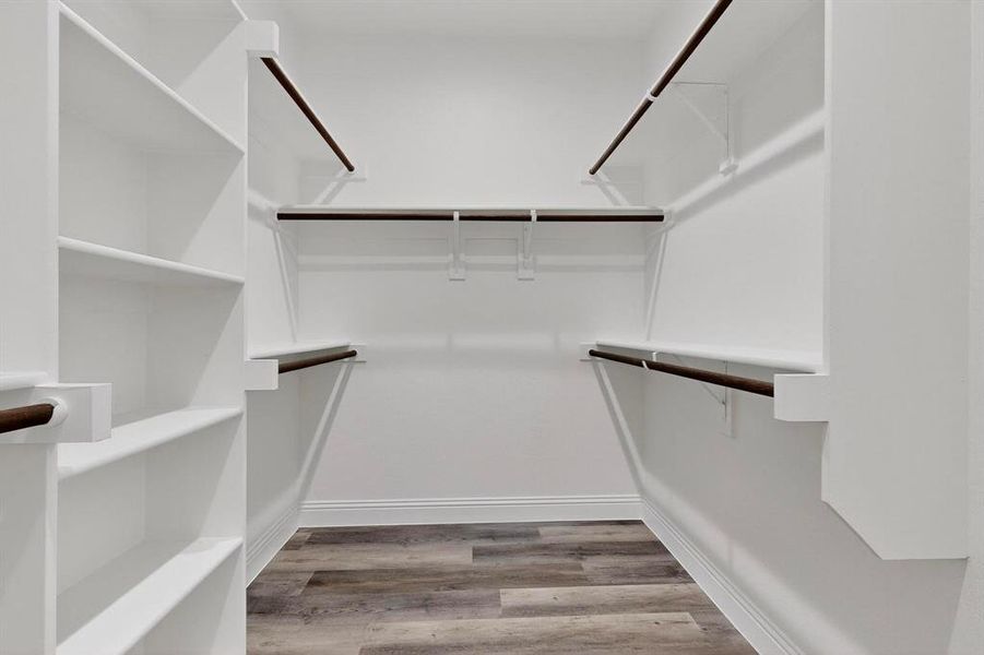 Spacious closet with light wood finished floors Spacious closet with light wood finished floors