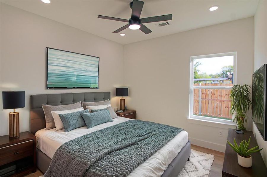 Bedroom with wood finished floors, recessed lighting, and a ceiling fan Bedroom with wood finished floors, recessed lighting, and a ceiling fan