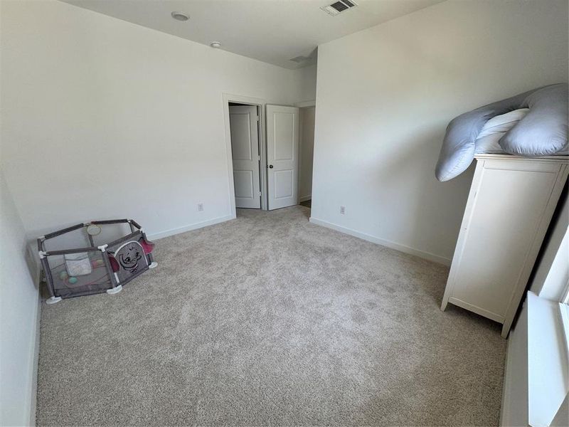 Bedroom with light colored carpet and baseboards Bedroom with light colored carpet and baseboards