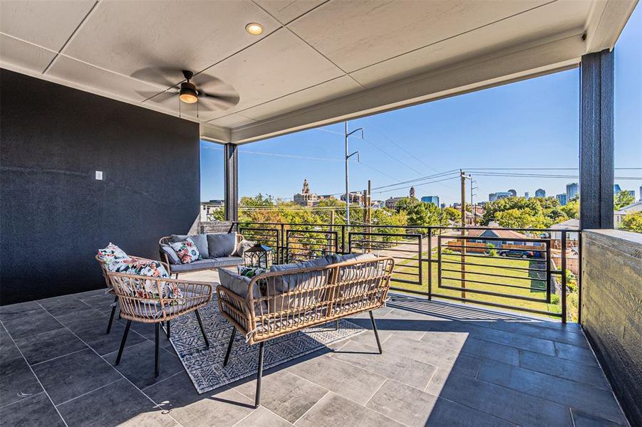 View of patio featuring ceiling fan, an outdoor hangout area, and a view of city View of patio featuring ceiling fan, an outdoor hangout area, and a view of city