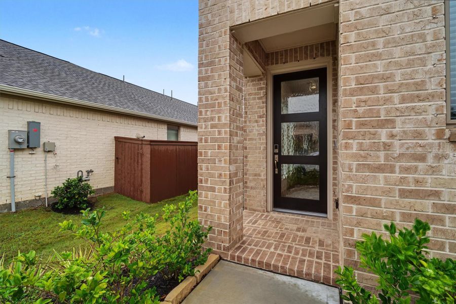 Covered front porch with designer front door Covered front porch with designer front door
