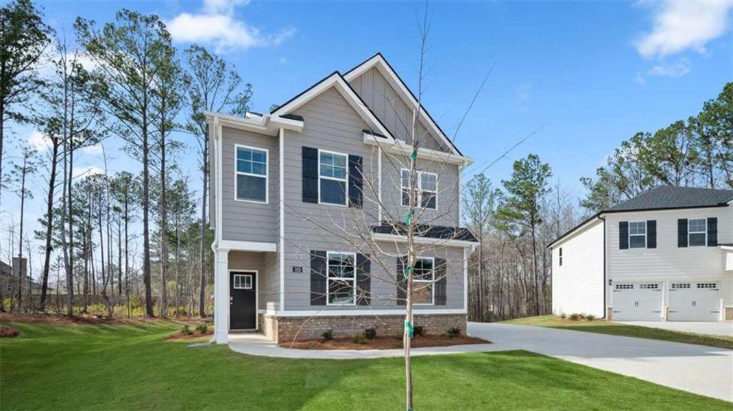 Front exterior of a new home in Oakchase at Hampton, Hampton, GA, highlighting curb appeal (Image 2). Front exterior of a new home in Oakchase at Hampton, Hampton, GA, highlighting curb appeal (Image 2).