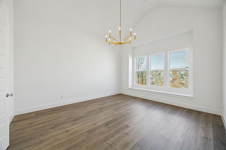 With high ceilings and a wall of windows, this peaceful and relaxing owner's suite is located at the rear of the home for additional privacy.