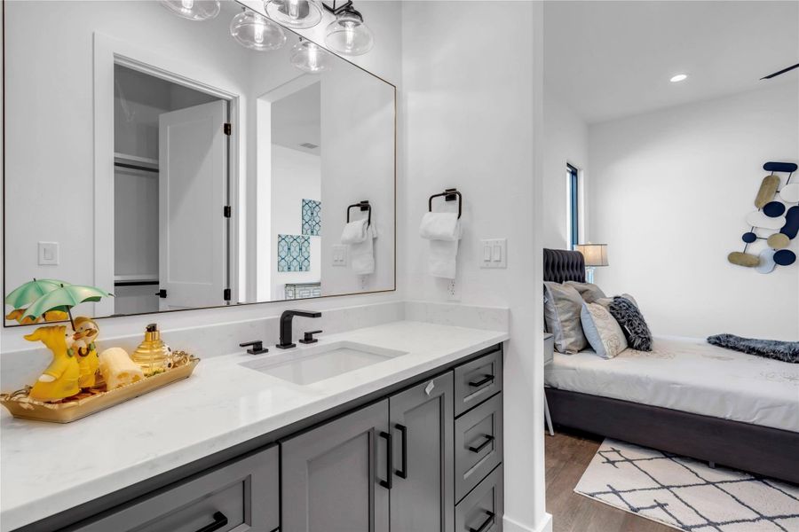 Bathroom with vanity, dark wood-type flooring, and recessed lighting