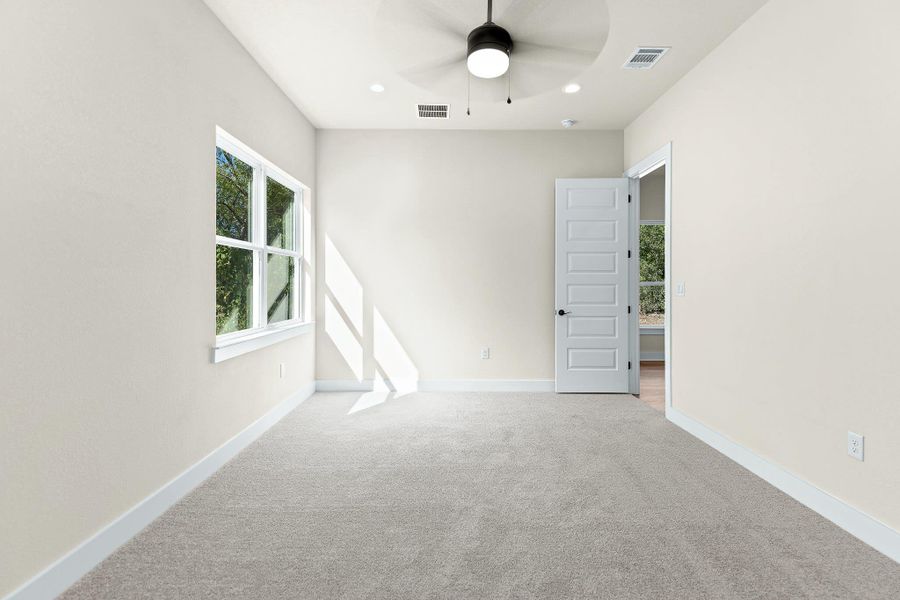 Carpeted spare room with a ceiling fan and recessed lighting