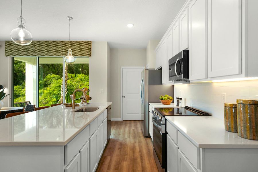 This Home Features White Cabinetry & Luxury Vinyl Plank Flooring