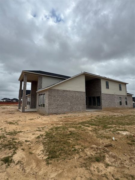 Showing off two outside living areas with covered patios
