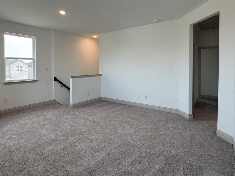 Empty room with attic access, carpet flooring, recessed lighting, and baseboards