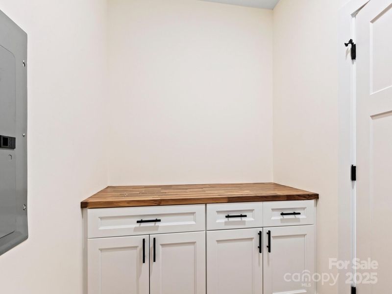 Laundryroom also has a counter for folding and additional storage below.  What would you store here?