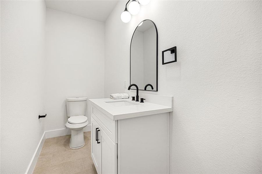 Half Bathroom-Elegant BathroomThis beautifully designed bathroom features a sleek vanity with quartz countertops, black fixtures, and modern lighting. The neutral tones and stylish finishes create a clean and sophisticated space, perfect for guests or everyday use!