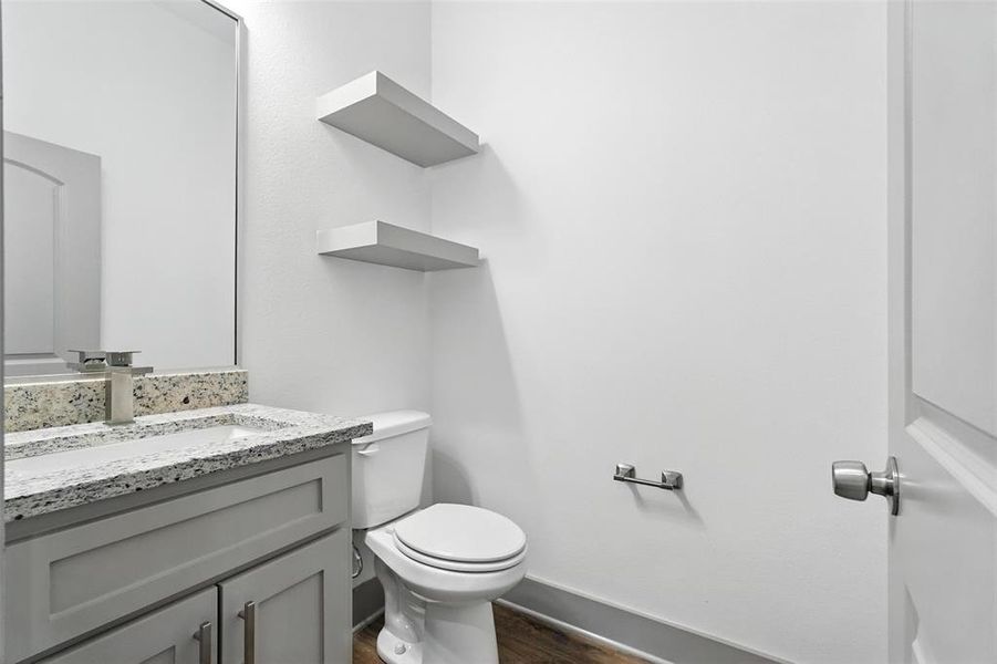 Half bath with vanity and dark wood-style floors Half bath with vanity and dark wood-style floors