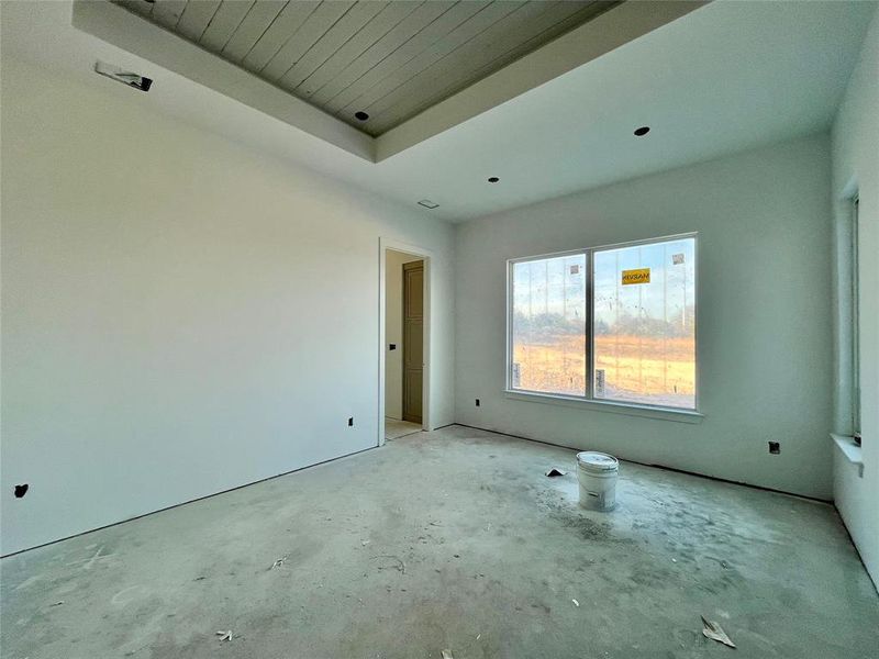 Empty room featuring a tray ceiling