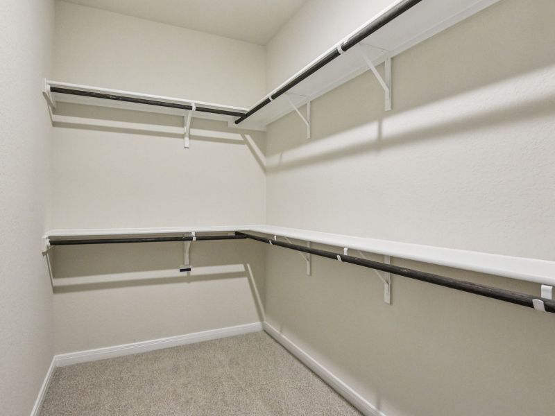 Primary suite walk-in closet in the Oleander floorplan at a Meritage Homes community.