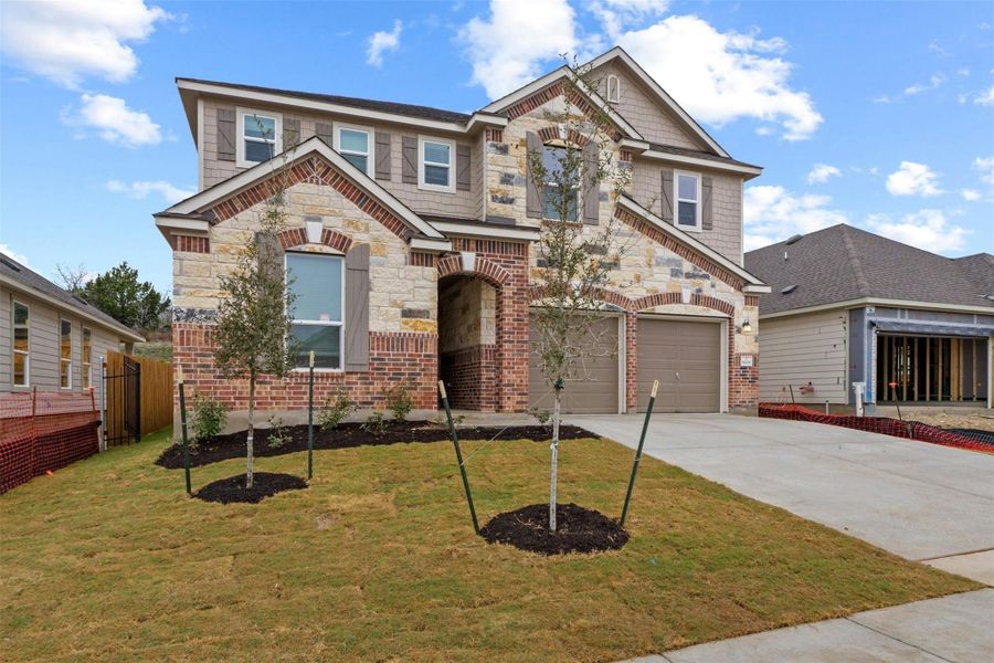 Front exterior of a new home in McKinney Crossing, Austin, TX, highlighting curb appeal (Image 22). Front exterior of a new home in McKinney Crossing, Austin, TX, highlighting curb appeal (Image 22).