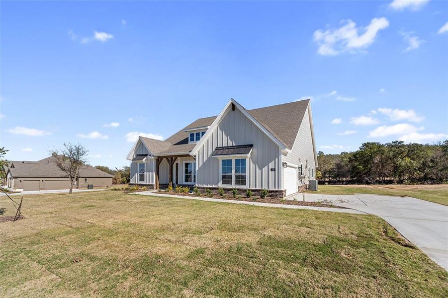 Front exterior of a new home in Oak Grove Addition, Springtown, TX, highlighting curb appeal (Image 23). Front exterior of a new home in Oak Grove Addition, Springtown, TX, highlighting curb appeal (Image 23).