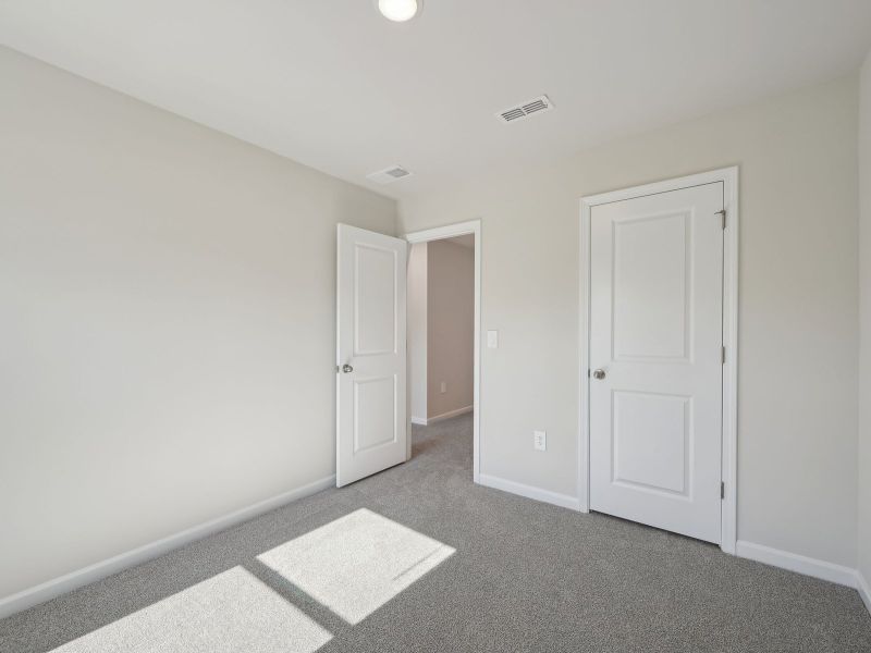Two secondary bedrooms are ideally situated away from the primary suite.