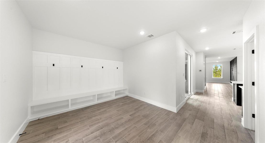 Mudroom with light wood finished floors and recessed lighting