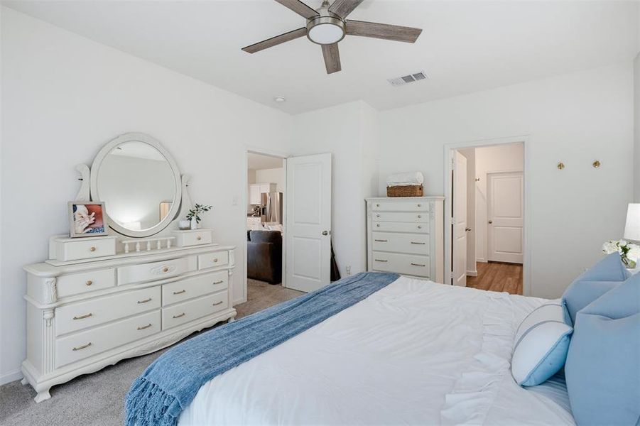 Bedroom featuring light gray carpeting and white walls