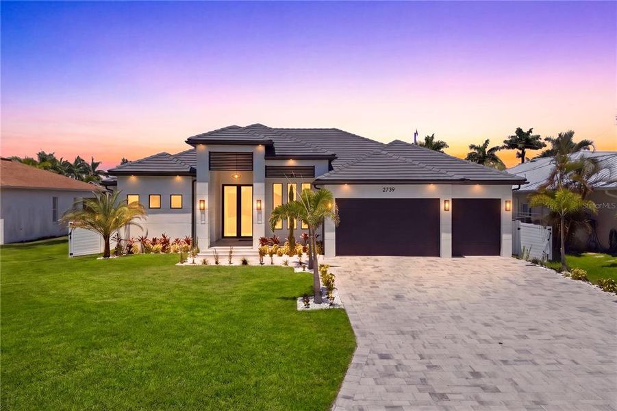 Front exterior of a new home in , Cape Coral, FL, highlighting curb appeal (Image 2). Front exterior of a new home in , Cape Coral, FL, highlighting curb appeal (Image 2).