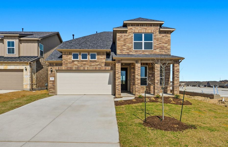 Front exterior of a new home in Sunfield, Buda, TX, highlighting curb appeal (Image 24).