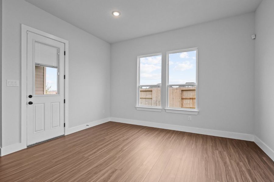 A room with a wood floor and a white door. A room with a wood floor and a white door.
