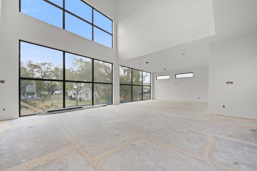 Grand entry with 26 foot ceilings and white okay straight lay flooring.