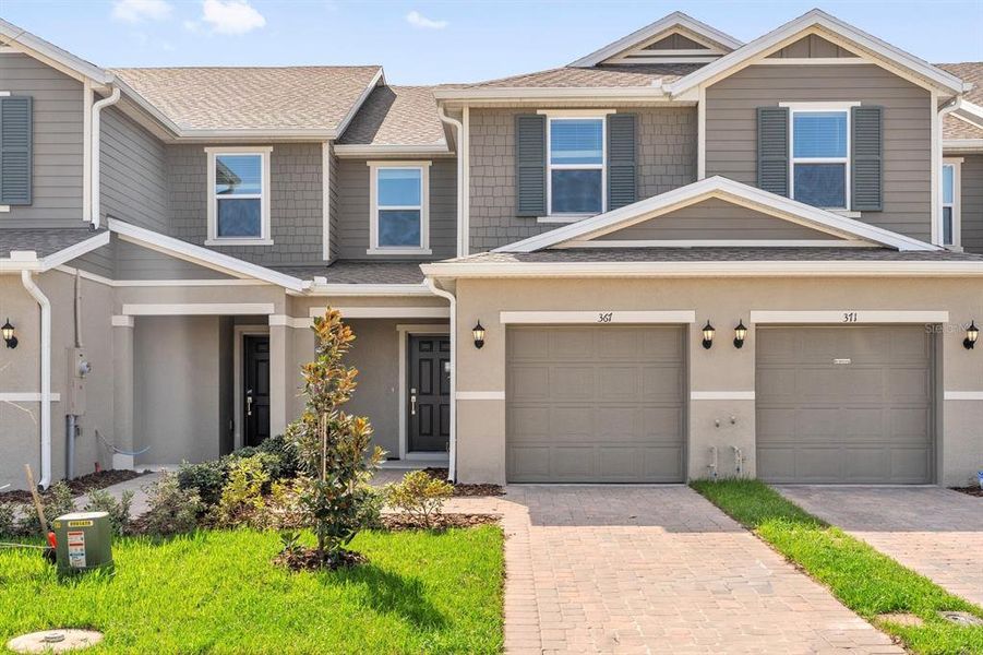 Front exterior of a new home in Reserve at Forest Lake Townhomes, Lake Wales, FL, highlighting curb appeal (Image 17).
