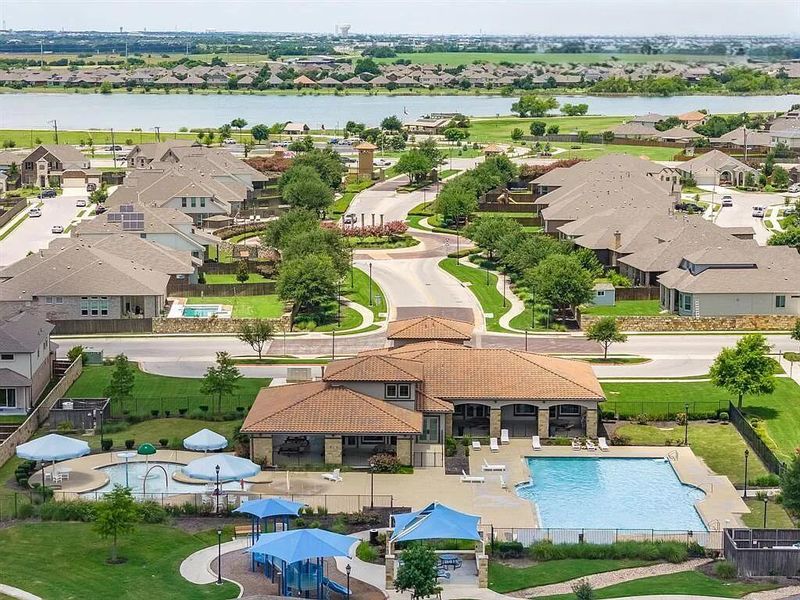 Aerial perspective of suburban area featuring a large body of water