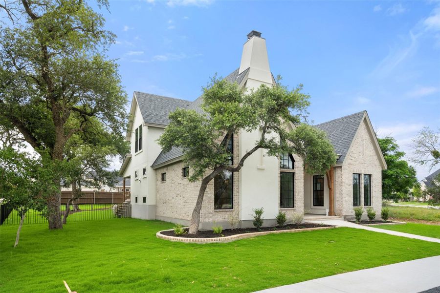 A striking contemporary residence boasts a grand facade with clean lines and mature trees framing the entry. A striking contemporary residence boasts a grand facade with clean lines and mature trees framing the entry.