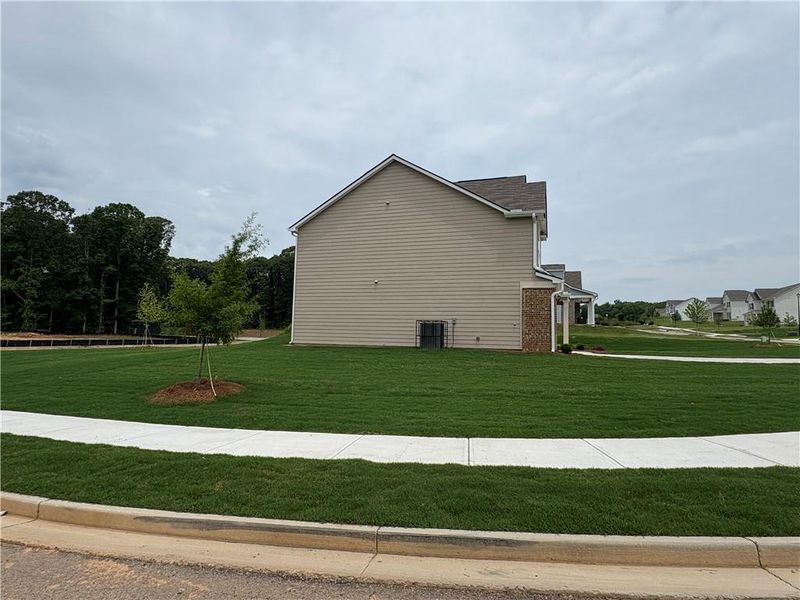 Front exterior of a new home in Highland Park, Stonecrest, GA, highlighting curb appeal (Image 2). Front exterior of a new home in Highland Park, Stonecrest, GA, highlighting curb appeal (Image 2).