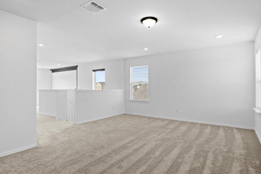 Unfurnished room with light carpet and recessed lighting