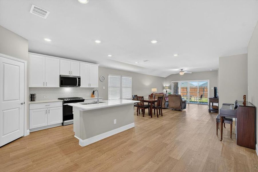 Open-concept interior featuring light wood-finish flooring throughout Open-concept interior featuring light wood-finish flooring throughout