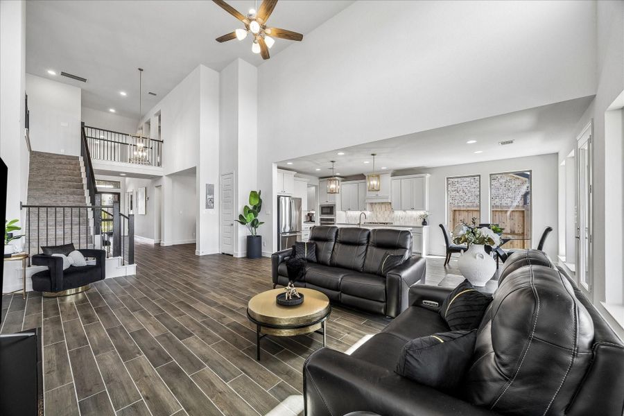 Spacious family room with soaring ceilings, expansive open-concept design and seamless flow into the kitchen and breakfast area
