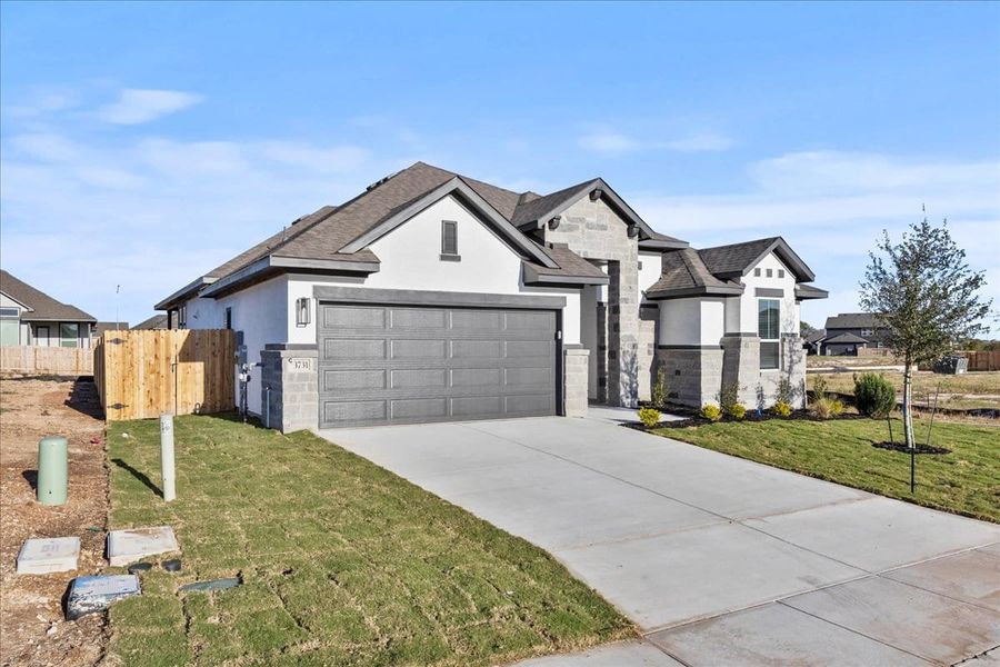 Front exterior of a new home in Village at Three Oaks, Seguin, TX, highlighting curb appeal (Image 21). Front exterior of a new home in Village at Three Oaks, Seguin, TX, highlighting curb appeal (Image 21).