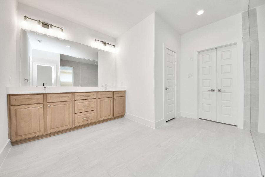 Elevate your daily routine at the elegant vanity, now equipped with double sinks, light countertops, modern hardware, and beautiful vanity lights. Elevate your daily routine at the elegant vanity, now equipped with double sinks, light countertops, modern hardware, and beautiful vanity lights.