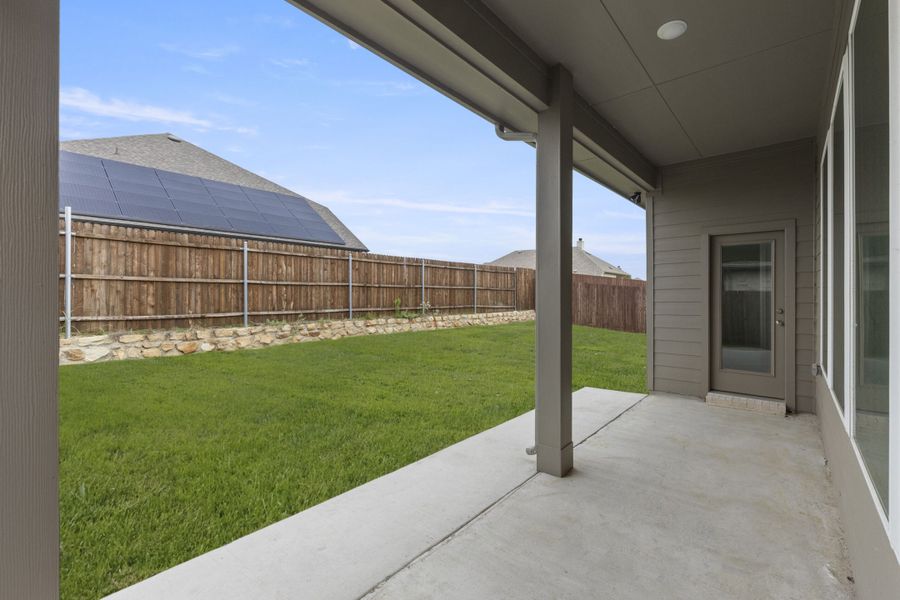 Exterior details and patio area of a home in Keeneland, Aubrey (Image 3).