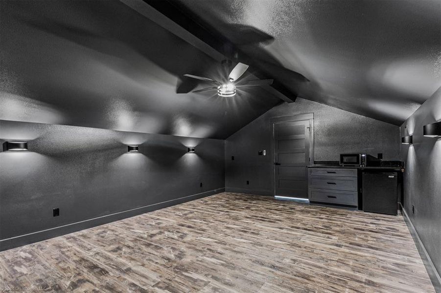 Media Room is wired for surround sound and wired to the media closet downstairs. Mini Fridge, Cabinetry, Microwave and Custom Lighting.