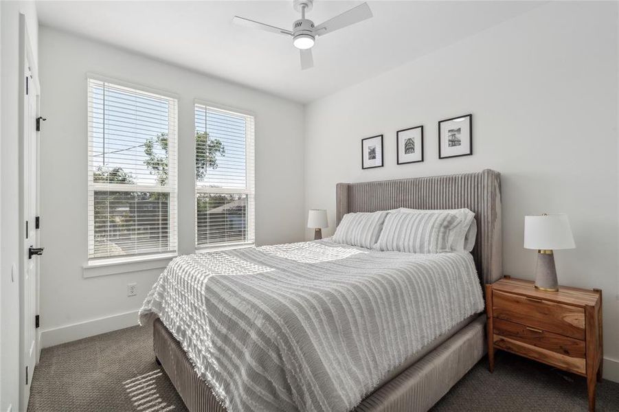 Bright and inviting secondary bedroom featuring large windows that provide abundant natural light.