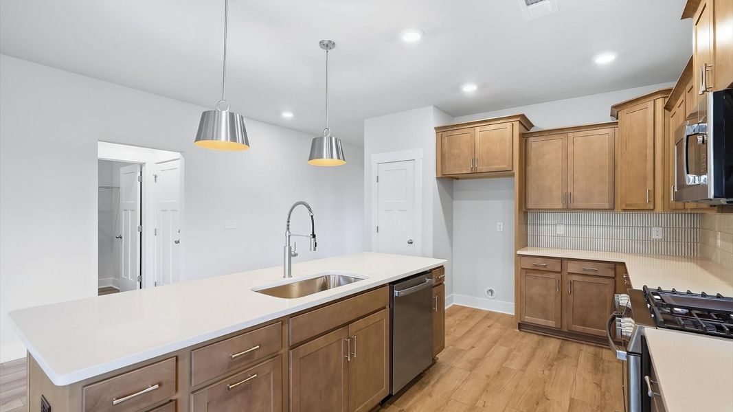 Exclusive kitchen design with large island, pendant lights, and tasteful finishes throughout