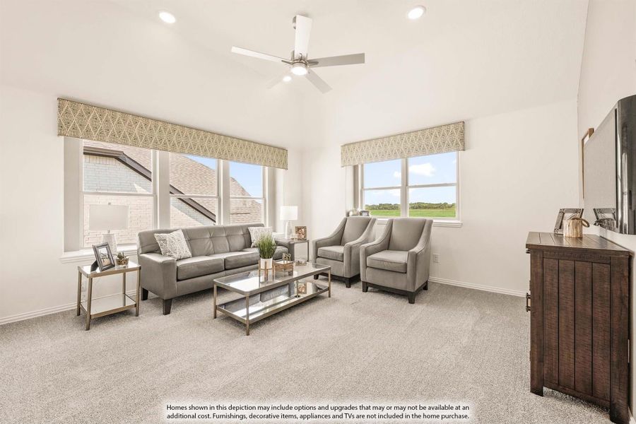 Living room with vaulted ceiling, ceiling fan, gray sofa and chairs, carpet flooring, and large windows with natural light.