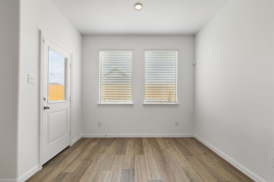 Empty room with light hardwood / wood-style flooring