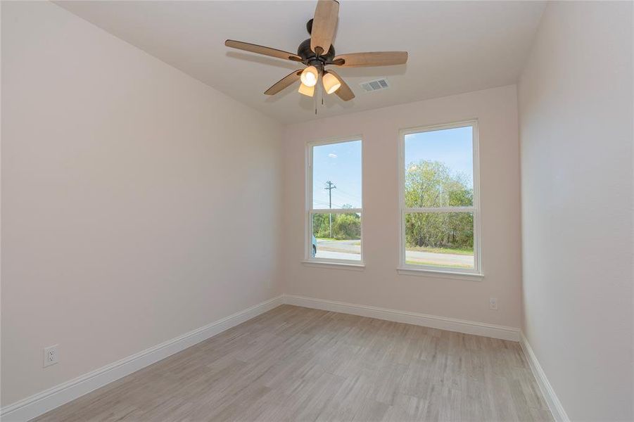 Spare room featuring light hardwood / wood-style floors and ceiling fan