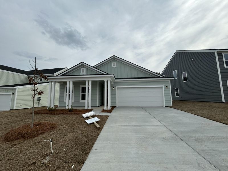 Front exterior of a new home in Tea Farm, Ravenel, SC, highlighting curb appeal (Image 19). Front exterior of a new home in Tea Farm, Ravenel, SC, highlighting curb appeal (Image 19).